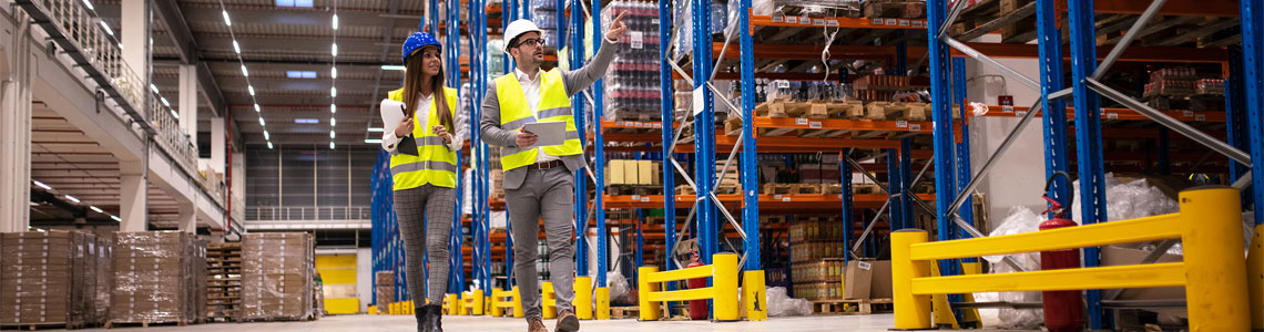 Woman and man walking through warehouse